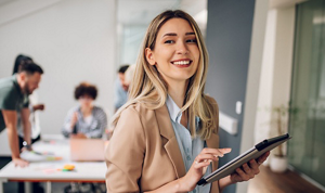 Professional blonde woman with long hair working in an open-plan office